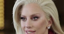 Lady Gaga with stylish blonde hair, wearing a red leather jacket, engaged in an animated conversation, showcasing her charisma.