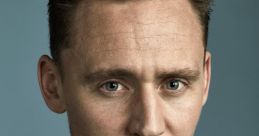 Tom Hiddleston, dressed in a classic tuxedo with a bow tie, gazes confidently against a blue background.