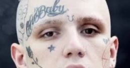 Portrait of a young man with distinctive tattoos and platinum blonde hair, showcasing a bold, alternative style.