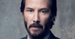 Keanu Reeves in a stylish suit, showcasing a charismatic and serious expression against a textured background.