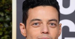 Rami Malek at the Golden Globe Awards, showcasing a stylish tuxedo with a bow tie, exuding elegance and charm.