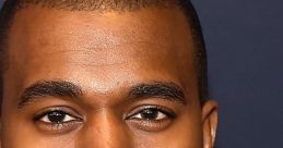 Kanye West poses confidently, showcasing his signature style and intense gaze at a prominent event.
