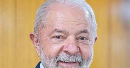 Luiz Inácio Lula Da Silva smiling, wearing a blue suit and tie, against a wooden background, showcasing his leadership presence.