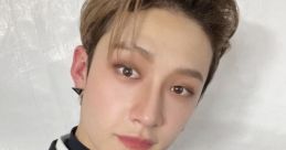 Bang Chan from Stray Kids poses confidently in stylish black attire, showcasing his signature charm and K-pop allure.
