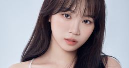 Kim Chaewon from LE SSERAFIM, with long hair, wearing a delicate white dress against a soft blue background.