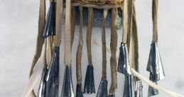Handcrafted wind chimes with metallic cones and woven basket top, showcased at the library for cultural display.