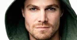 Close-up of a man in a green hoodie holding a sharp tool, evoking themes from Arrow and character dynamics.