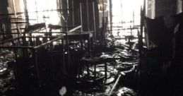 Devastated interior of a destroyed library, showcasing burned furniture and debris after a catastrophic fire incident.