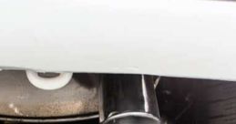 Exhaust smoke billowing from a car's tailpipe, illustrating engine idle performance issues and emissions concerns.