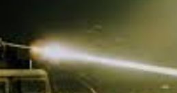 Military vehicle firing in a desert landscape, showcasing advanced technology and tactical capabilities in action.