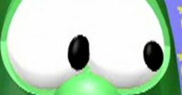 Larry the Cucumber character from VeggieTales, featuring a playful expression and bright green color on a colorful background.