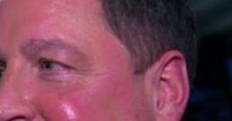 Tony Chimel smiling at an event, showcasing his signature look in formal attire, reflecting his presence in the wrestling community.
