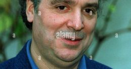 Michael Angelis, renowned actor, smiling in a blue jacket, captured in 1993, showcasing his engaging personality.