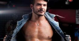 Portrait of a muscular man in a denim jacket and striped pants, embodying confidence and edgy style in a nightlife setting.