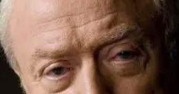 Michael Caine with a thoughtful expression, showcasing his signature style and distinguished features in a close-up portrait.