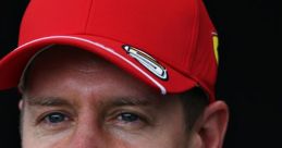 Sebastian Vettel smiling in a red Ferrari cap, showcasing his charismatic personality and racing spirit.