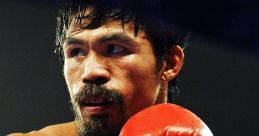 Manny Pacquiao in red boxing gloves prepares for a fight, showcasing his intense focus and athletic physique.