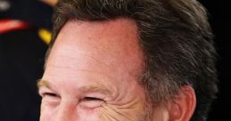 Christian Horner smiles during a race event, showcasing his leadership at Red Bull Racing and passion for motorsport.