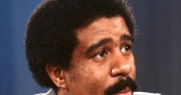 Richard Pryor in a classic interview, showcasing his distinctive hairstyle and thoughtful expression. Legendary comedian.