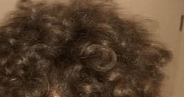 Smiling young man with curly hair, showcasing vibrant personality and playful energy, perfect for Jmancurly content.