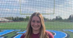 Katelyn M. Folweiler poses in a Bloomsburg University t-shirt on a sports field, showcasing school spirit and athletic pride.