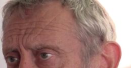 Close-up of Michael Rosen, known for his calm demeanor, showcasing thoughtful expression and unique hairstyle.