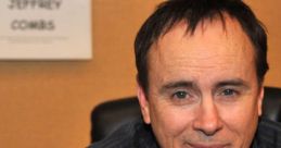 Jeffrey Combs smiles while promoting his role as Ratchet, showcasing his charismatic presence at an event.