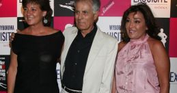 Three elegantly dressed individuals pose at an event featuring Edgar Viza, showcasing a vibrant backdrop with branding.