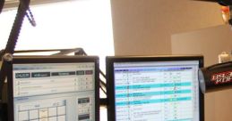 Professional radio broadcast studio setup featuring control panels and dual monitors for seamless programming.