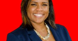 Tanisha Taylor wearing a navy blazer and statement necklace, smiling confidently against a bright red background.