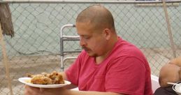 Man with a plate of food and a drink sits outdoors, highlighting the struggles featured in My 600 Pound Life.