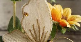 Elegant gold butterfly ornament among vibrant yellow flowers, perfect for juty decoration and floral arrangements.