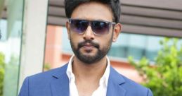 Stylish man in a blue suit with sunglasses, exuding confidence and modern elegance outdoors. Perfect for fashion inspiration.
