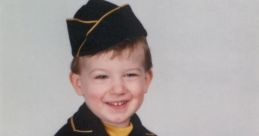 Smiling young boy in a vintage black and yellow outfit, exuding charm and innocence with a playful pose.