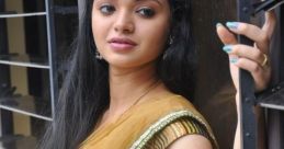 Young woman in elegant traditional attire, showcasing grace and style with a golden saree and intricate accessories.