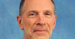 Maxwell Bachenheimer smiling in a casual green shirt against a blue background, showcasing his approachable demeanor.