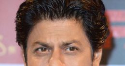 Shahrukh Khan, the renowned Bollywood actor, showcases his signature style and charisma at a public event.