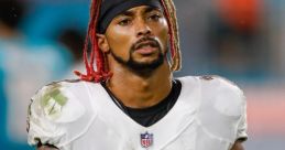 Anthony CB in action, wearing Ravens jersey 23, showcasing determination on the field during a night game.