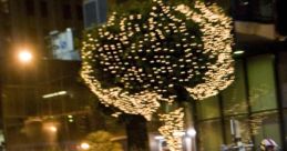 Orange sports car performing a drift on a city street adorned with festive lights, capturing the spirit of Tokyo Drift.