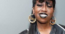 Missy Elliott showcases her bold style with striking makeup and a stylish leather jacket, exuding confidence and creativity.