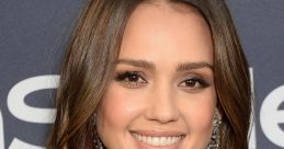 Jessica Alba smiles beautifully, showcasing her long hair and elegant earrings at a glamorous event.