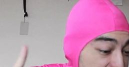 Person in a pink suit gestures passionately, embodying the quirky and humorous spirit associated with Pink Guy.