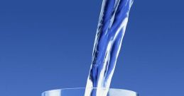 Clear water pouring into a glass, creating bubbles against a vibrant blue background. Perfect for hydration ideas.