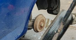 Car Jack Clunking The clunking of a car jack lifting a vehicle off the ground reverberates through the garage, a metallic