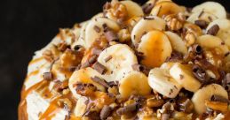 Delicious banana cake layered with creamy frosting, topped with fresh bananas, chocolate shavings, and caramel drizzle.