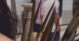 Young woman in a striped dress stands in focus, with two people strolling in the background, highlighting summer vibes.