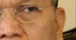 Close-up of a Filipino figure, focused expression, glasses, and professional attire, representing leadership in the Philippines.