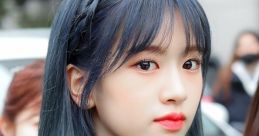 YuJin, a popular Korean artist, showcases stunning blue hair and a captivating look, perfect for fans and fashion enthusiasts.