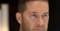 Professional man in a suit with a focused expression, representing confidence and sophistication for "Whispering - Jason.