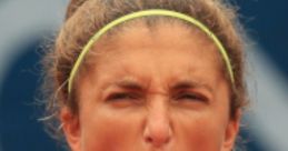 Athlete expressing intense emotion by shouting during a match, conveying determination and competitive spirit.